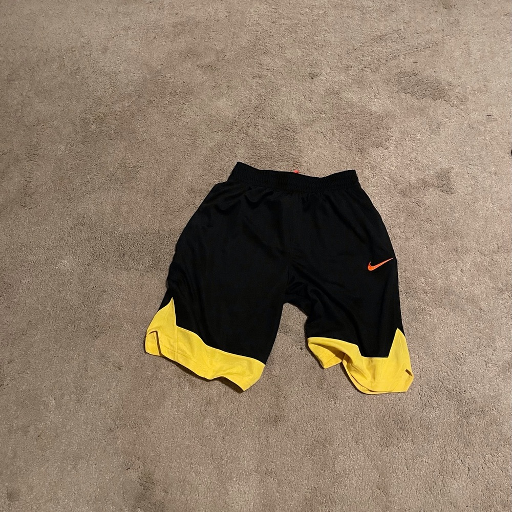 Black Nike shorts with Yellow on the bottoms